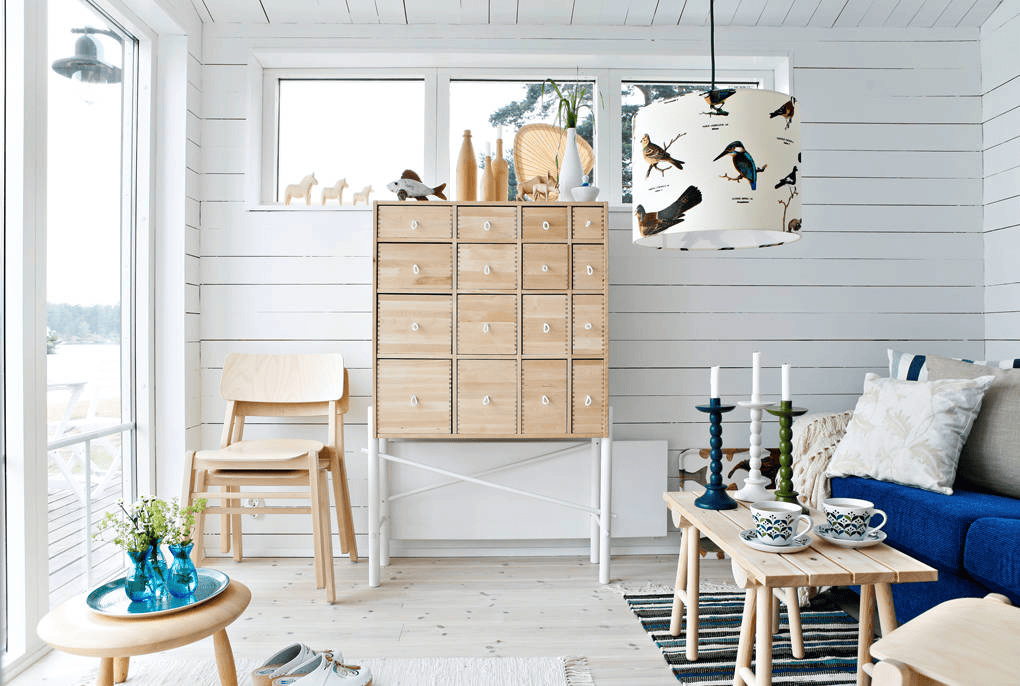 Coastal inspired room highlighting Hamptons interior design style defined by crisp white finishes, soft blue tones, and abundant natural light