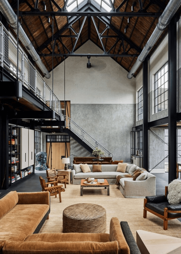 Urban loft setting featuring Industrial interior design style with raw exposed structural elements, metal fixtures, and weathered wood details
